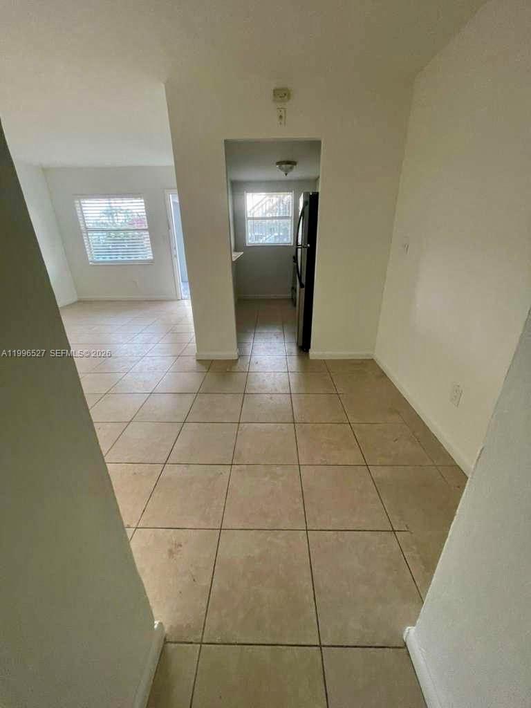 7101 Southwest 89th Court, Unit 102 Miami, FL 33173 - Photo 6 of 7 a view of an empty room and window