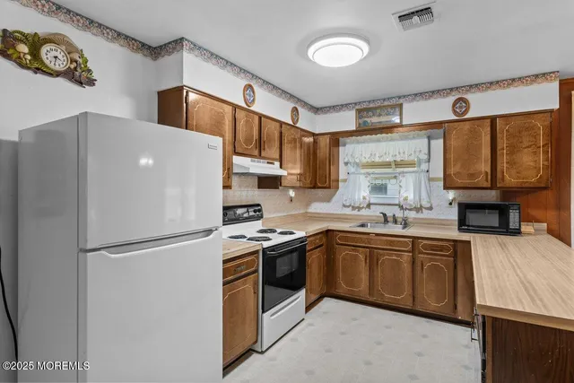 a white refrigerator freezer sitting inside of a kitchen