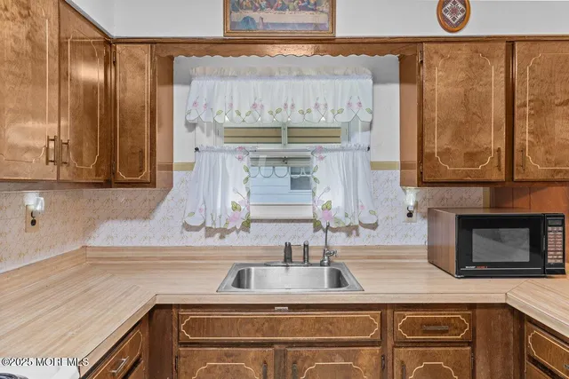 a kitchen with granite countertop a stove and a sink