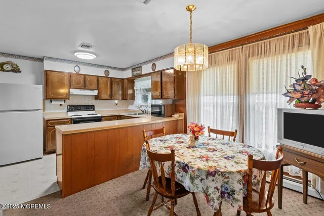 a dining room filled with furniture and chandelier