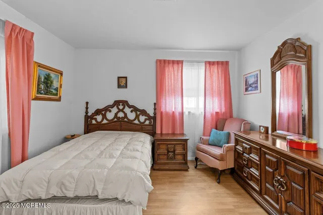 a bedroom with a bed couch and window