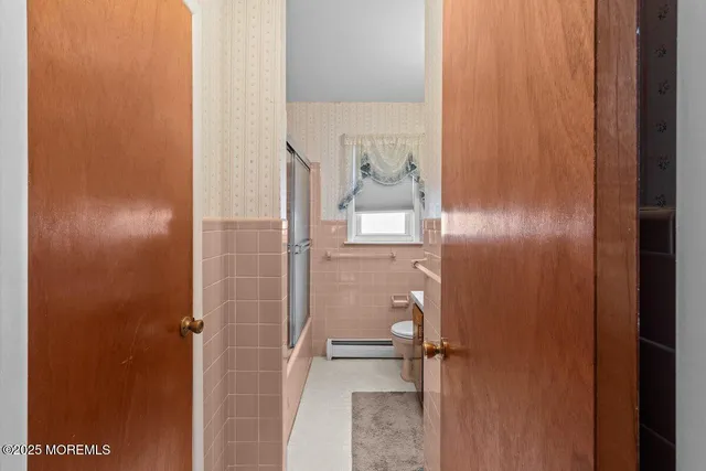 a bathroom with a glass shower door