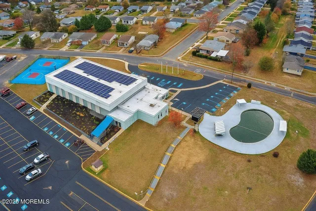 an aerial view of a pool patio kitchen and outdoor seating