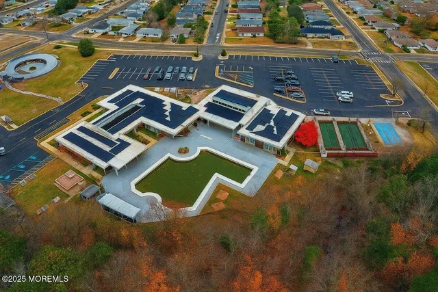 an aerial view of a house with a yard