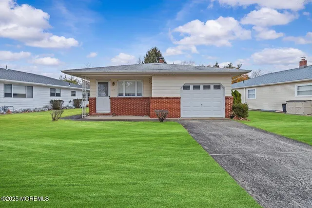 a front view of house with yard and entertaining space