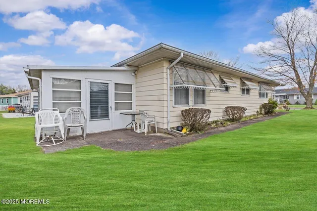 a front view of house with yard and outdoor seating