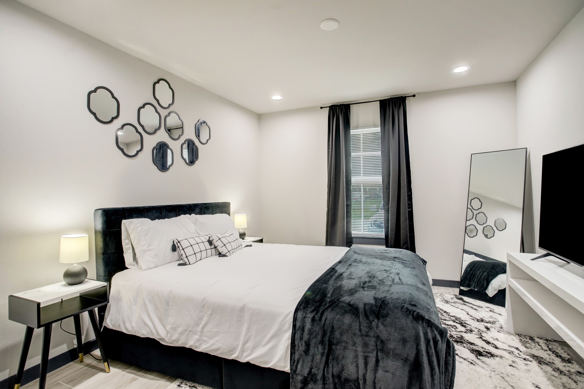 3448 Elgin Street, Unit 5 Houston, TX 77004 - Photo 3 of 8 a bedroom with a bed and a flat screen tv