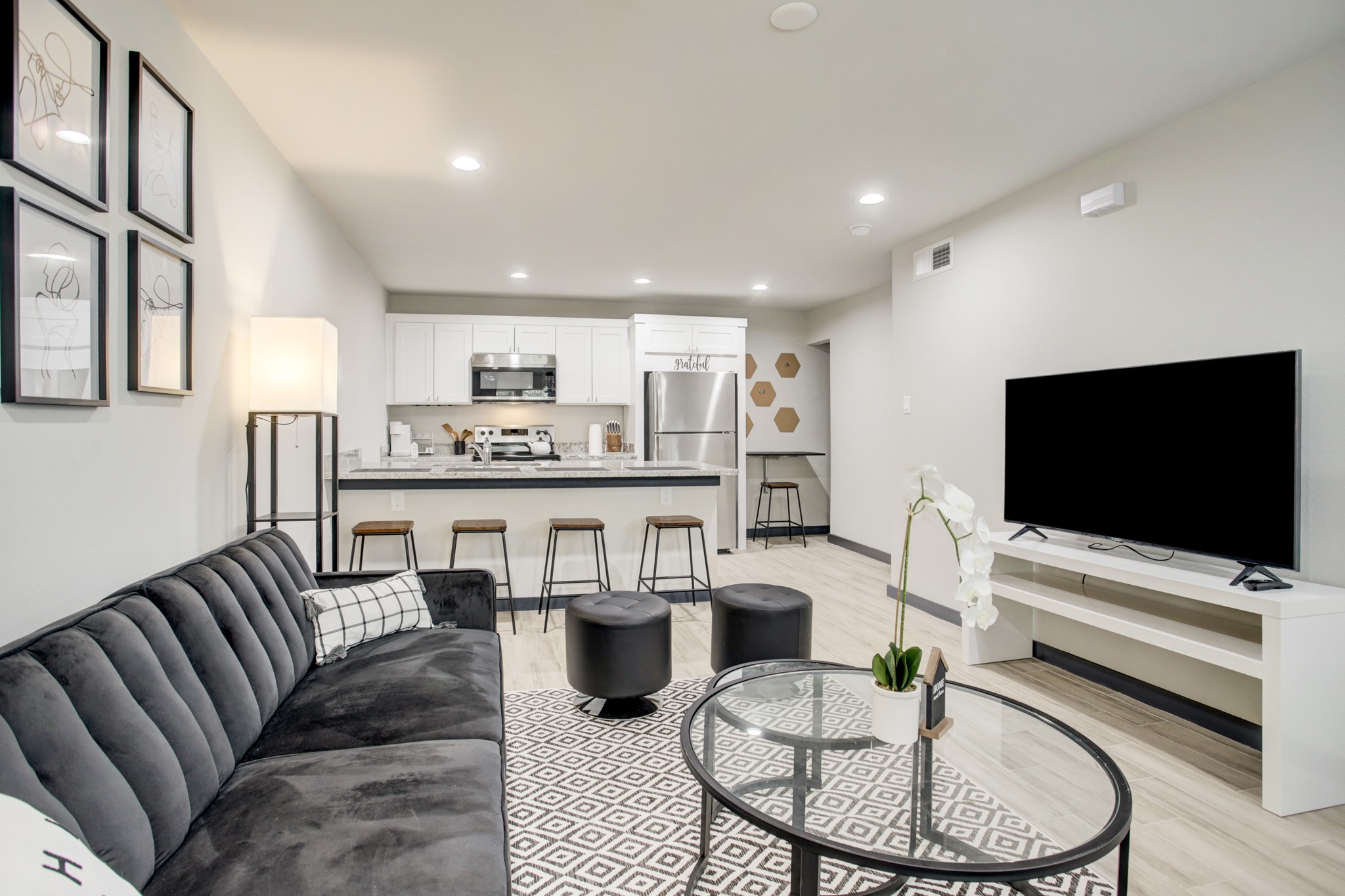 3448 Elgin Street, Unit 5 Houston, TX 77004 - Photo 7 of 8 a living room with furniture and a flat screen tv