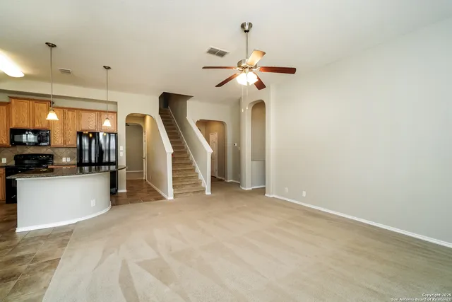 a view of a kitchen with furniture and a ceiling fan
