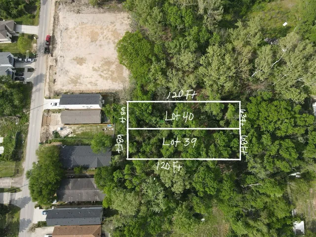 a view of a backyard with wooden fence