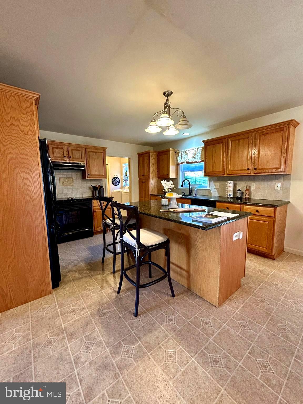 214 Pumping Station Road Quarryville, PA 17566 - Photo 6 of 46 a kitchen with kitchen island granite countertop wooden cabinets a counter top space and stainless steel appliances