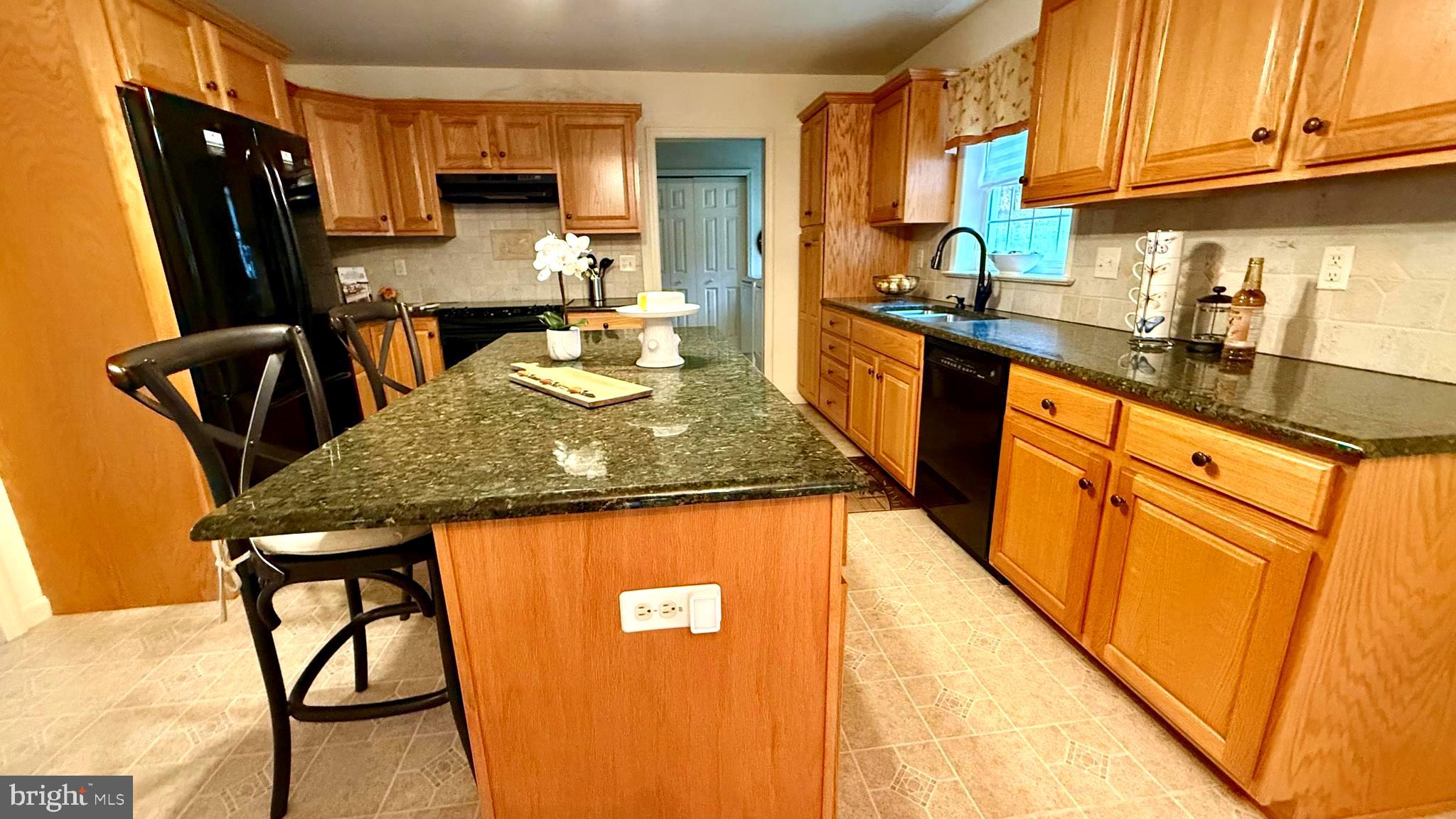 214 Pumping Station Road Quarryville, PA 17566 - Photo 9 of 46 a kitchen with stainless steel appliances granite countertop sink stove top oven table and chairs
