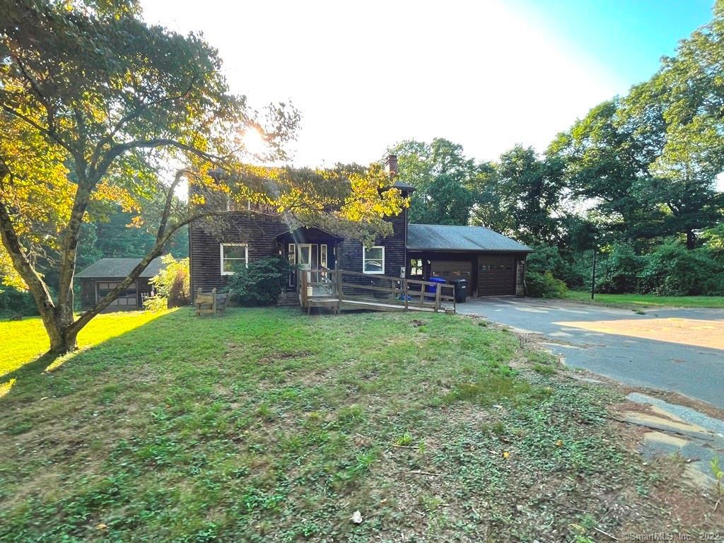 881 North River Road Coventry, CT 06238 - Photo 1 of 1 a front view of a house with a yard table and chairs