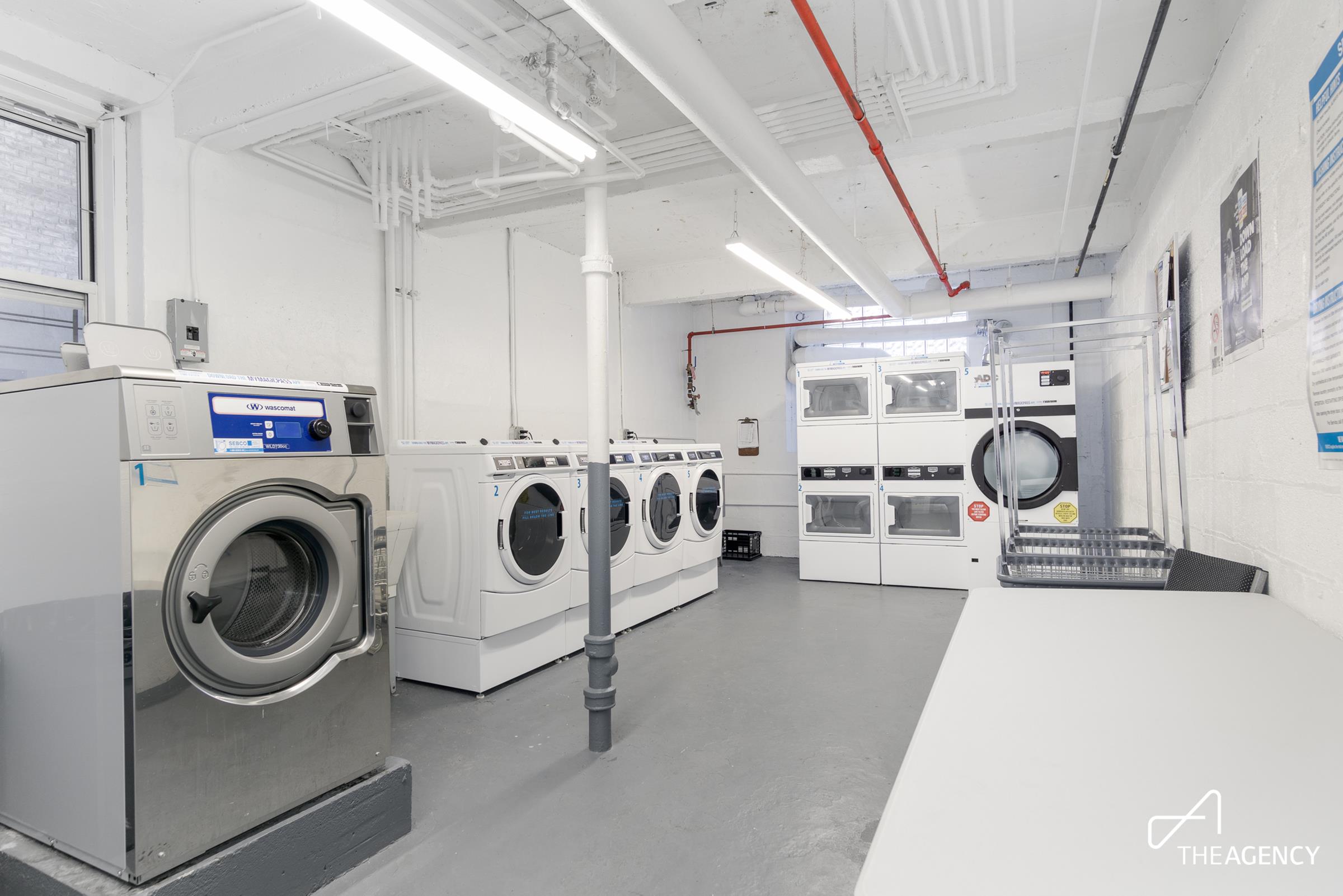 153 Bennett Avenue, Unit 3G Manhattan, NY 10040 - Photo 10 of 14 a utility room with multiple dryer and washer