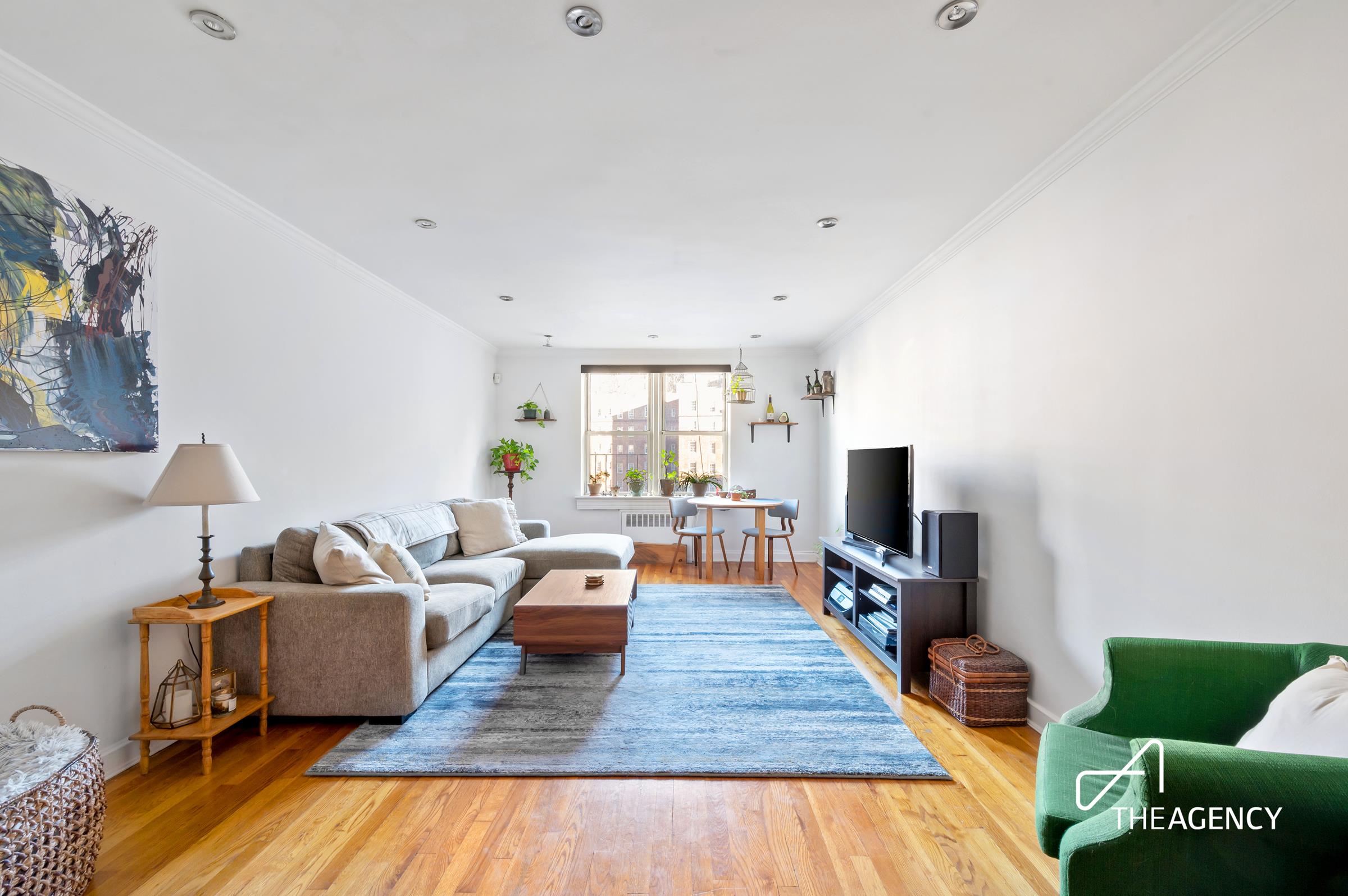 153 Bennett Avenue, Unit 3G Manhattan, NY 10040 - Photo 2 of 14 a living room with furniture and a wooden floor