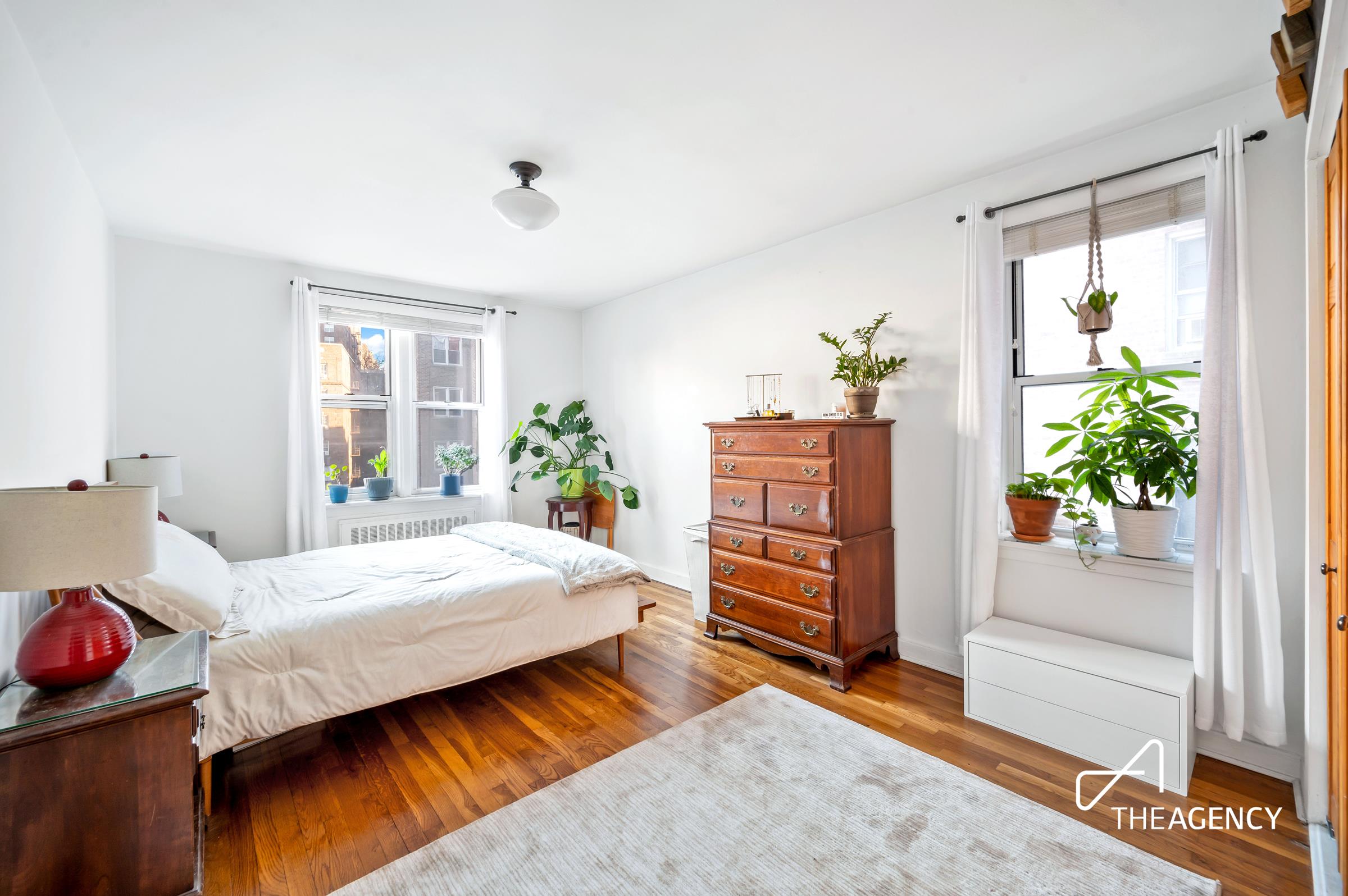 153 Bennett Avenue, Unit 3G Manhattan, NY 10040 - Photo 7 of 14 a bedroom with a bed table and a potted plant