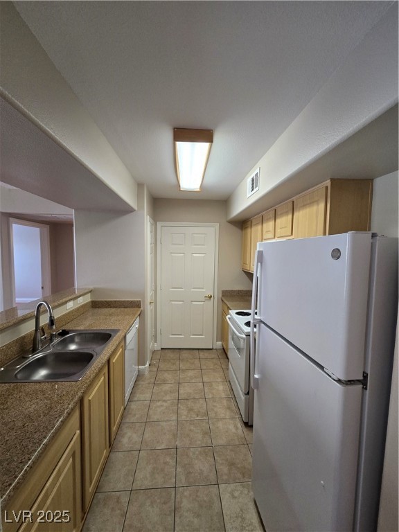 8000 West Badura Avenue, Unit 2135 Las Vegas, NV 89113 - Photo 14 of 28 Kitchen featuring stainless steel refrigerator, stove, light tile patterned floors, light brown cabinets, and dishwasher