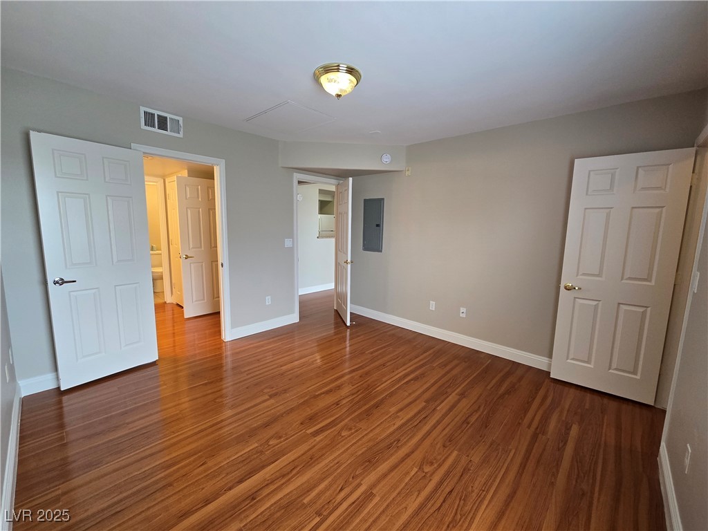 8000 West Badura Avenue, Unit 2135 Las Vegas, NV 89113 - Photo 16 of 28 Unfurnished bedroom featuring dark wood-style floors and electric panel