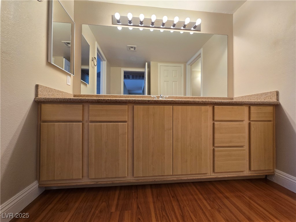 8000 West Badura Avenue, Unit 2135 Las Vegas, NV 89113 - Photo 17 of 28 Bathroom with vanity, a textured wall, and dark wood-style floors