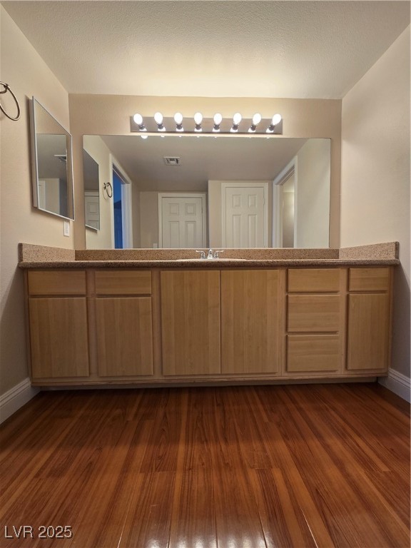 8000 West Badura Avenue, Unit 2135 Las Vegas, NV 89113 - Photo 18 of 28 Bathroom with vanity and dark wood-style floors