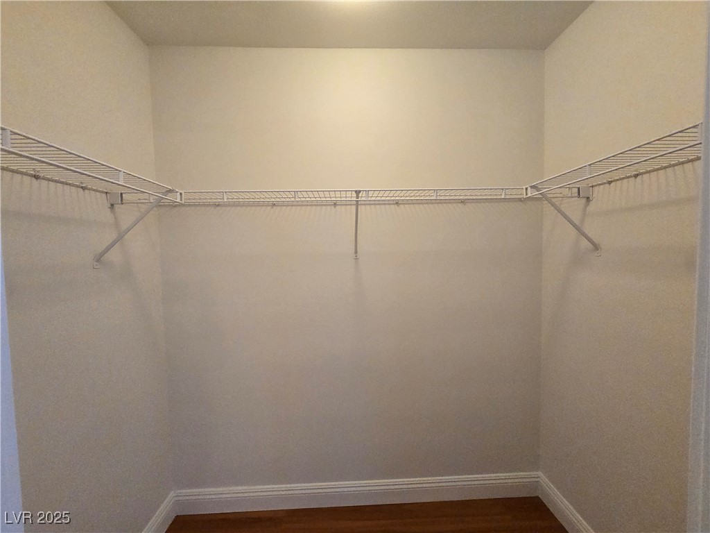 8000 West Badura Avenue, Unit 2135 Las Vegas, NV 89113 - Photo 22 of 28 Spacious closet with dark wood finished floors