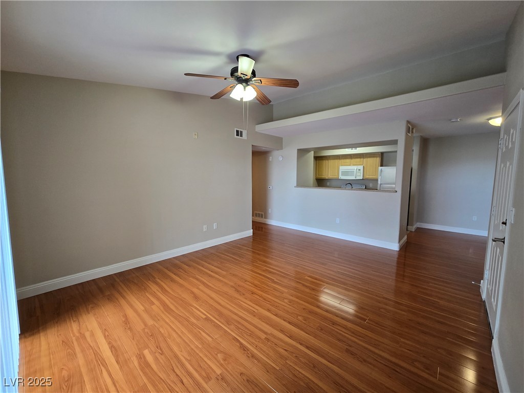 8000 West Badura Avenue, Unit 2135 Las Vegas, NV 89113 - Photo 5 of 28 Empty room with dark wood-type flooring and a ceiling fan