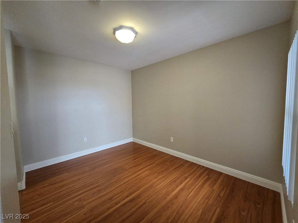 8000 West Badura Avenue, Unit 2135 Las Vegas, NV 89113 - Photo 8 of 28 Unfurnished room with dark wood-type flooring and baseboards