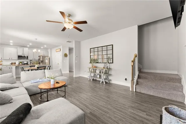 a kitchen with refrigerator a sink and chairs