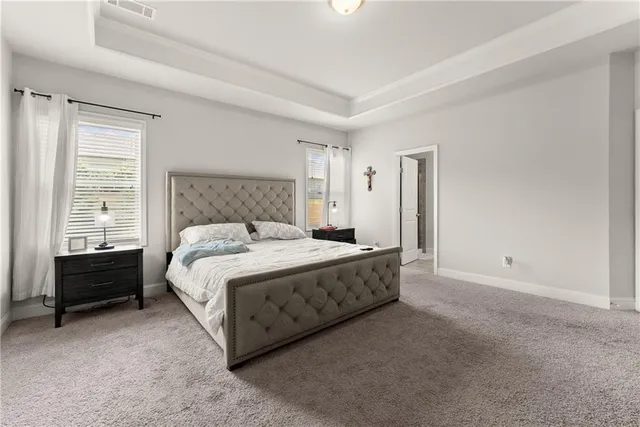 a spacious bedroom with a bed and a window