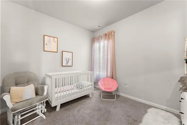 a room with painting on the wall and a dresser