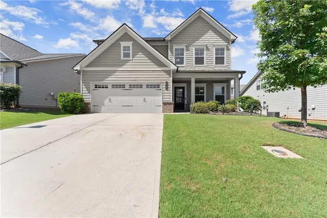 a front view of a house with a yard
