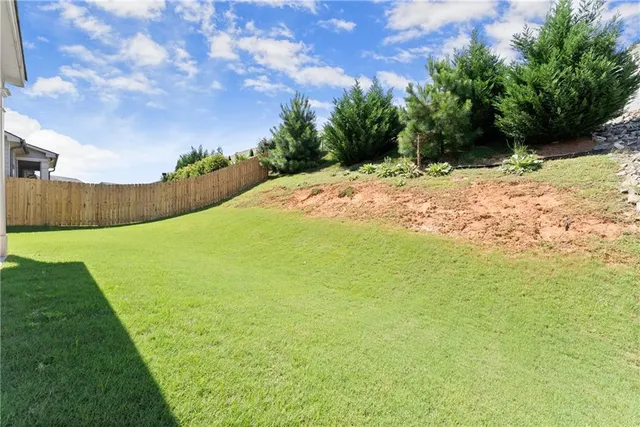 a view of a house with a yard and sitting area