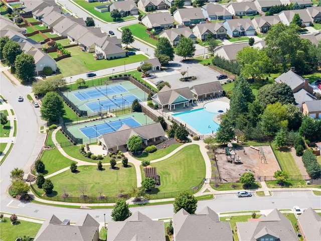 a hallway with wooden floor and staircase