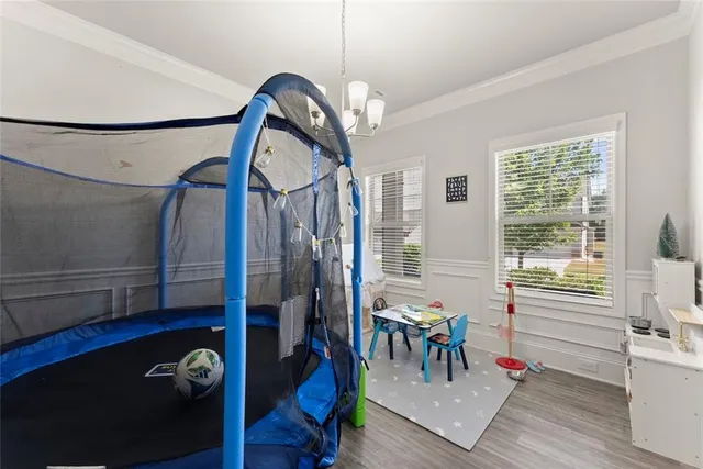 a living room with furniture kitchen view and a wooden floor