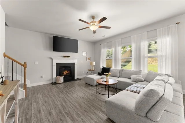 a living room with furniture and kitchen view