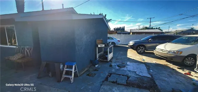 a view of a backyard with table and chairs