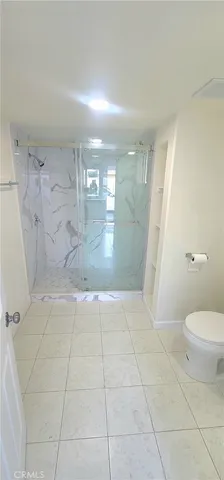 a hallway with sliding door and chandelier