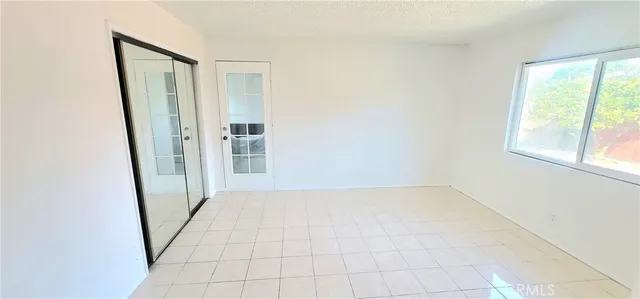 an empty room with windows and entrance