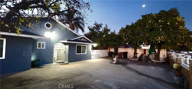 a view of a house with sitting area and covered with trees