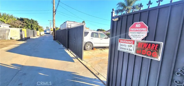 a view of a house with wooden fence
