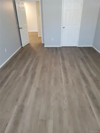 a view of a room with wooden floor