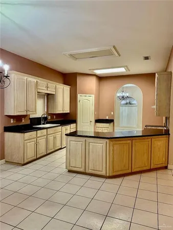a kitchen with granite countertop a stove a sink and a microwave