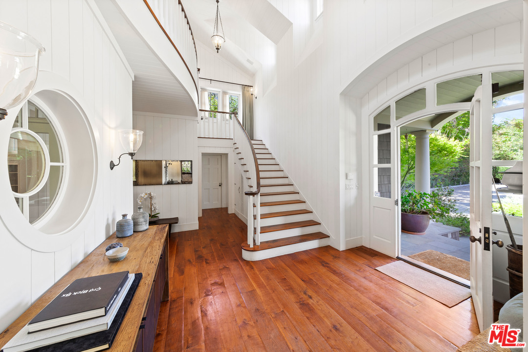 6763 Zumirez Drive Malibu, CA 90265 - Photo 13 of 52 a view of a livingroom with wooden floor and furniture