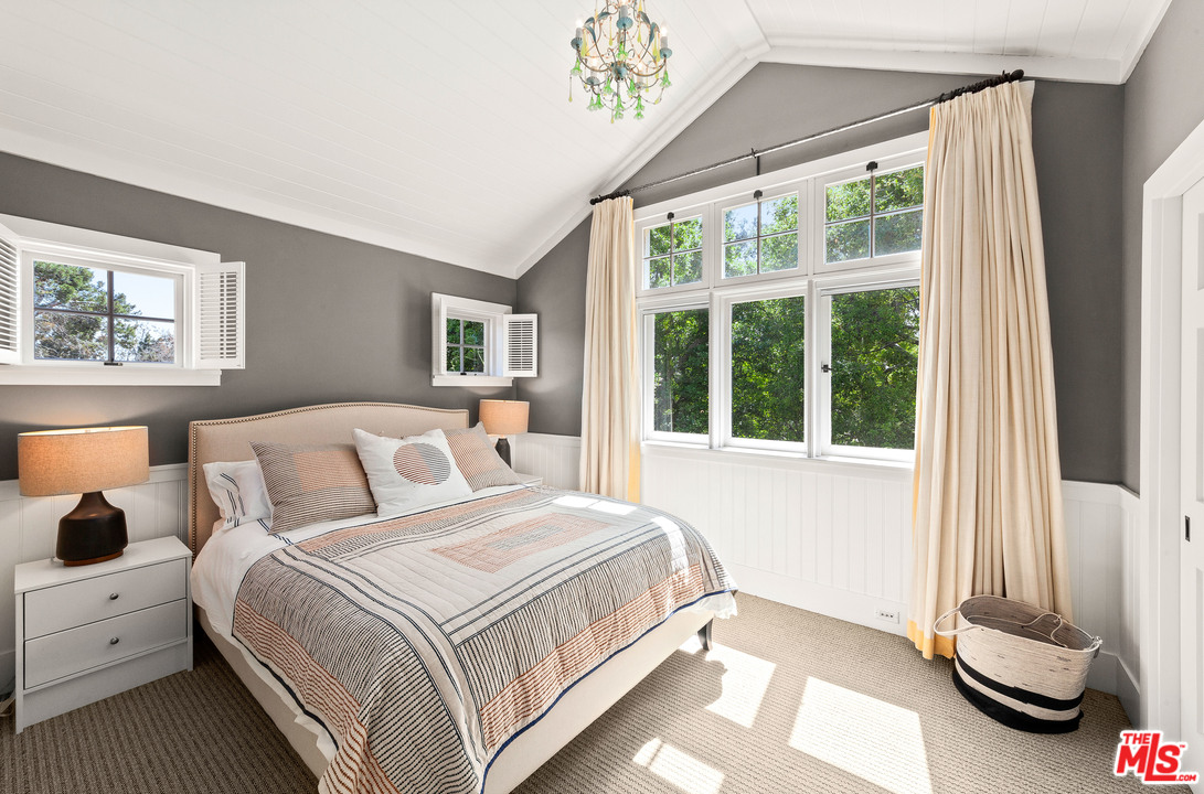 6763 Zumirez Drive Malibu, CA 90265 - Photo 23 of 52 a bedroom with a bed and a window