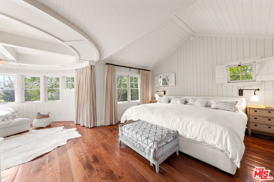6763 Zumirez Drive Malibu, CA 90265 - Photo 27 of 52 a bedroom with a large bed and a window