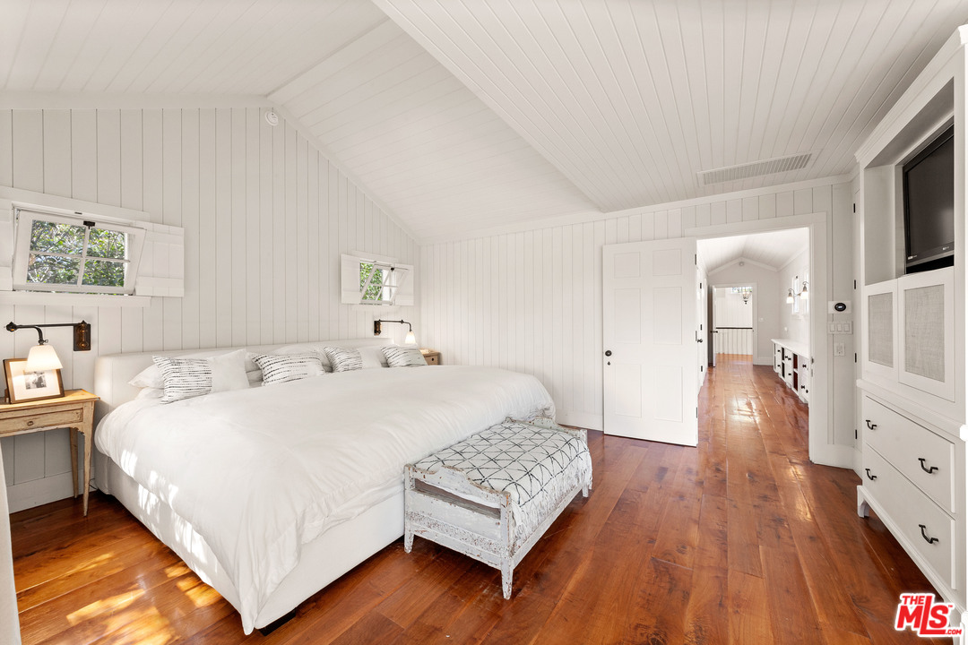 6763 Zumirez Drive Malibu, CA 90265 - Photo 28 of 52 a bedroom with a bed and a view of living room