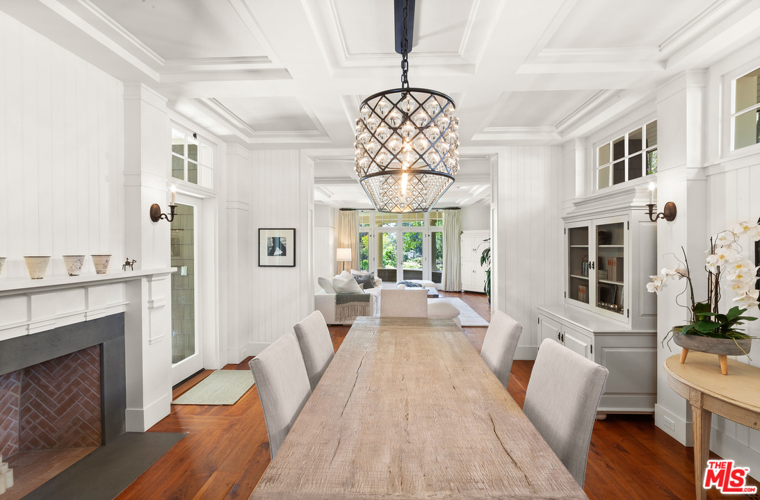 6763 Zumirez Drive Malibu, CA 90265 - Photo 4 of 52 a view of a dining room with furniture a chandelier and wooden floor