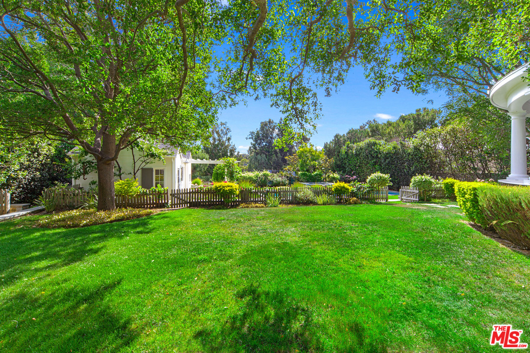 6763 Zumirez Drive Malibu, CA 90265 - Photo 33 of 52 a view of backyard of house with green space