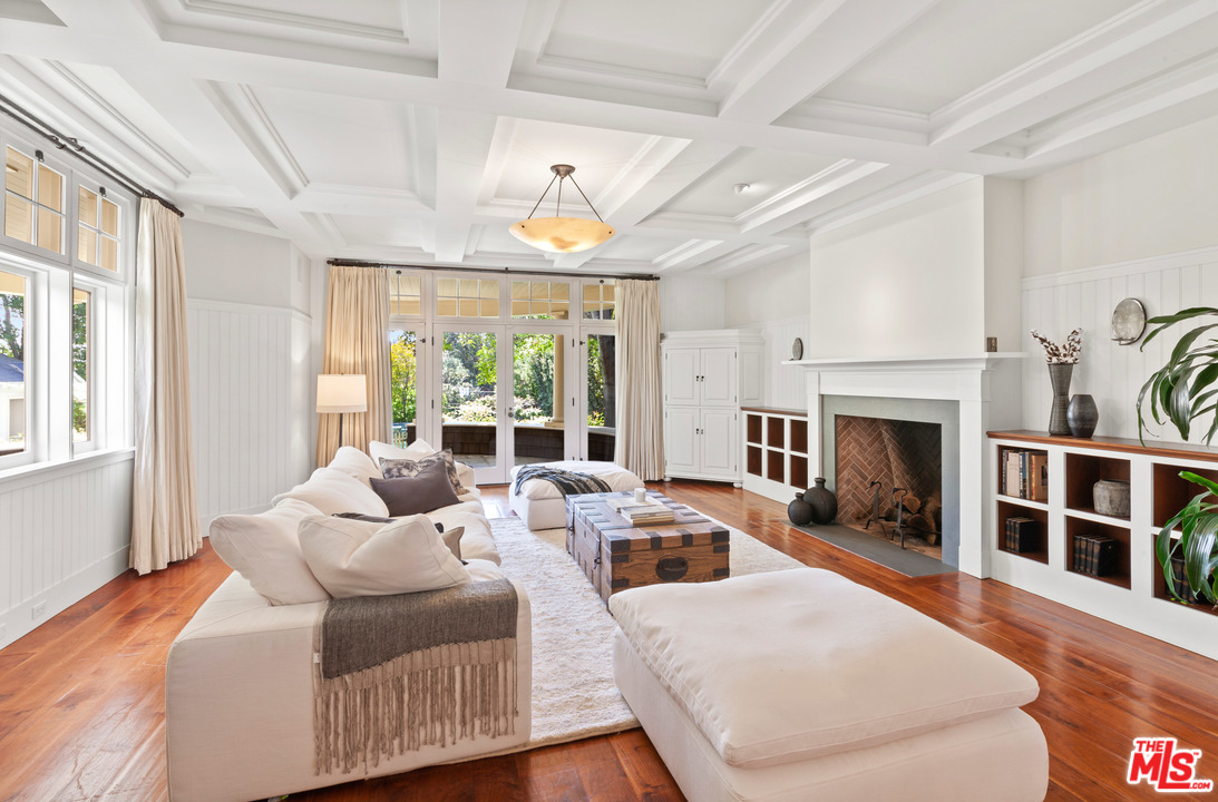 6763 Zumirez Drive Malibu, CA 90265 - Photo 5 of 52 a living room with furniture large window and fireplace