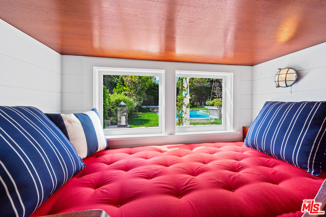 6763 Zumirez Drive Malibu, CA 90265 - Photo 42 of 52 a bedroom with a bed and window